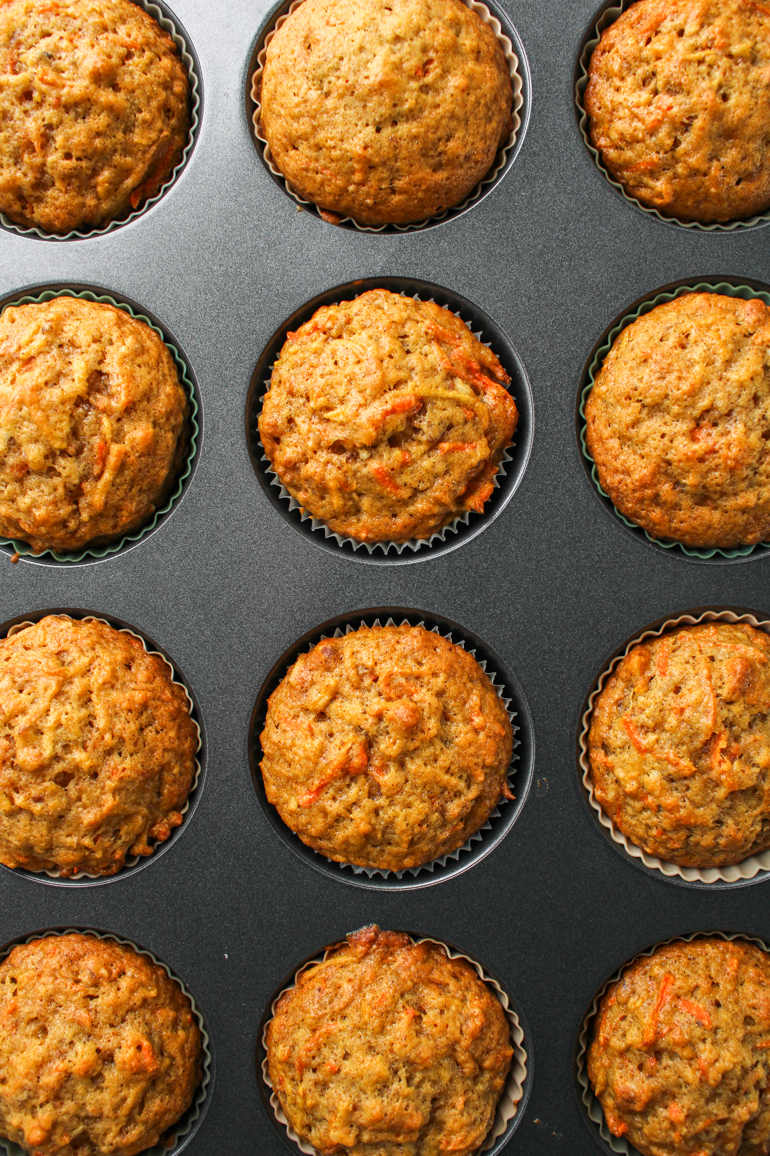 overhead shot of baked carrot apple muffins in the baking pan