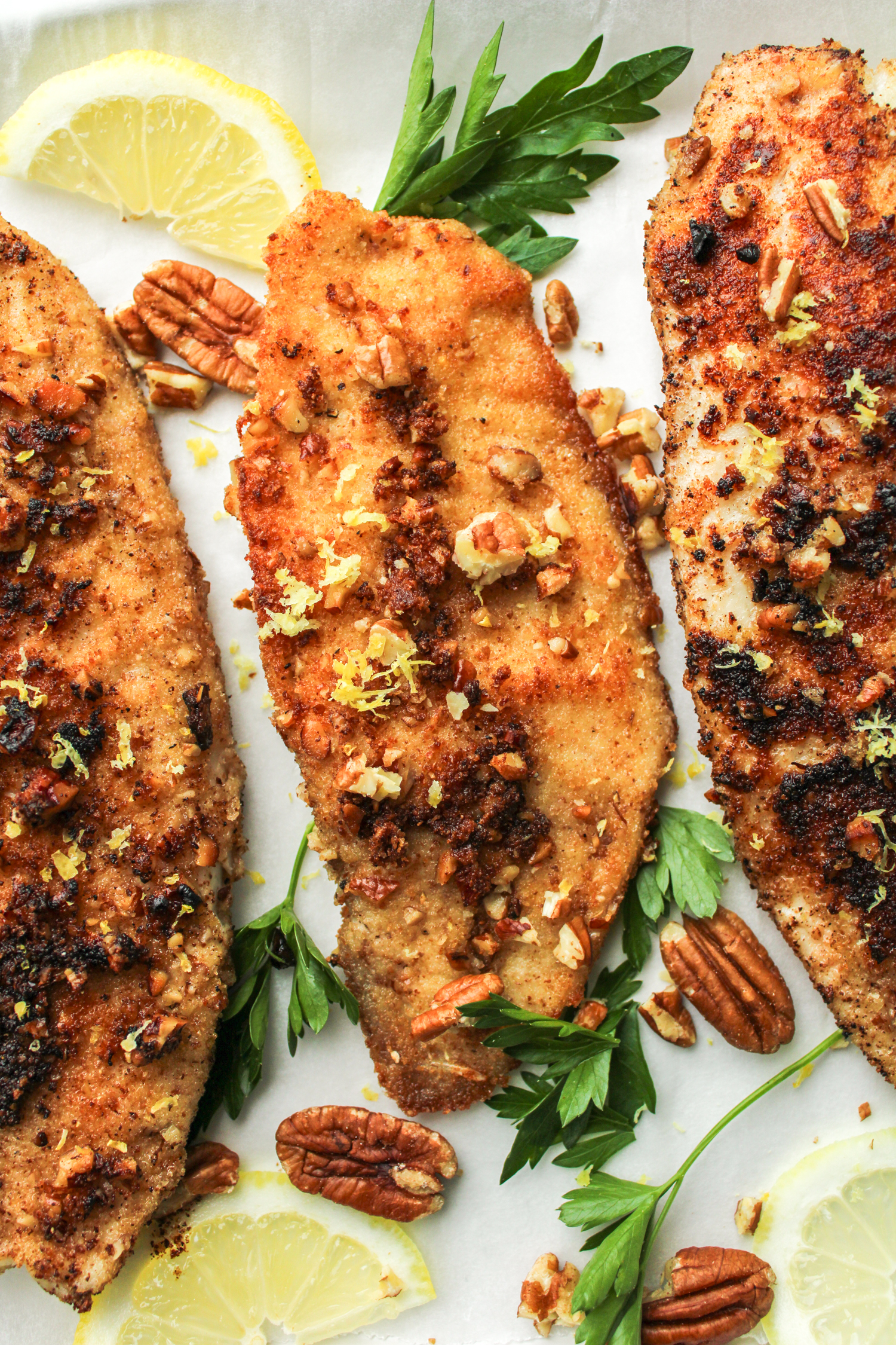 3 fillets of pecan crusted tilapia topped with chopped pecans, lemon zest and parsley