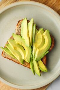 toast with avocado on grey ceramic plate