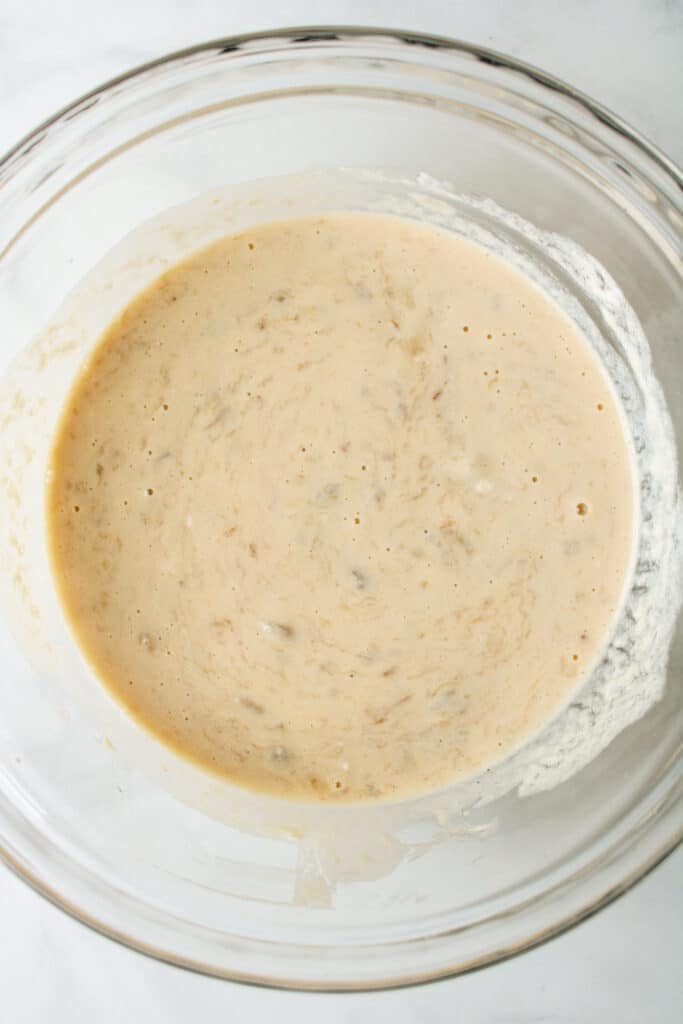 wet ingredients for banana bread in a glass bowl