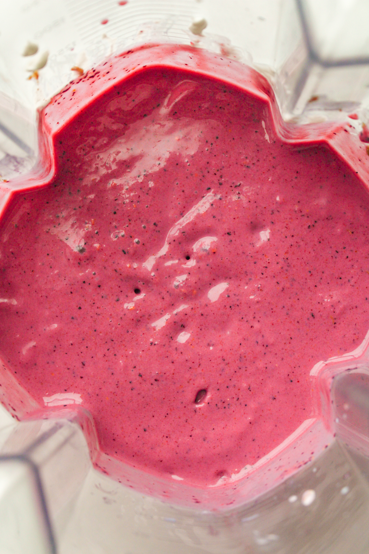 overhead shot of pink blended smoothie in the blender