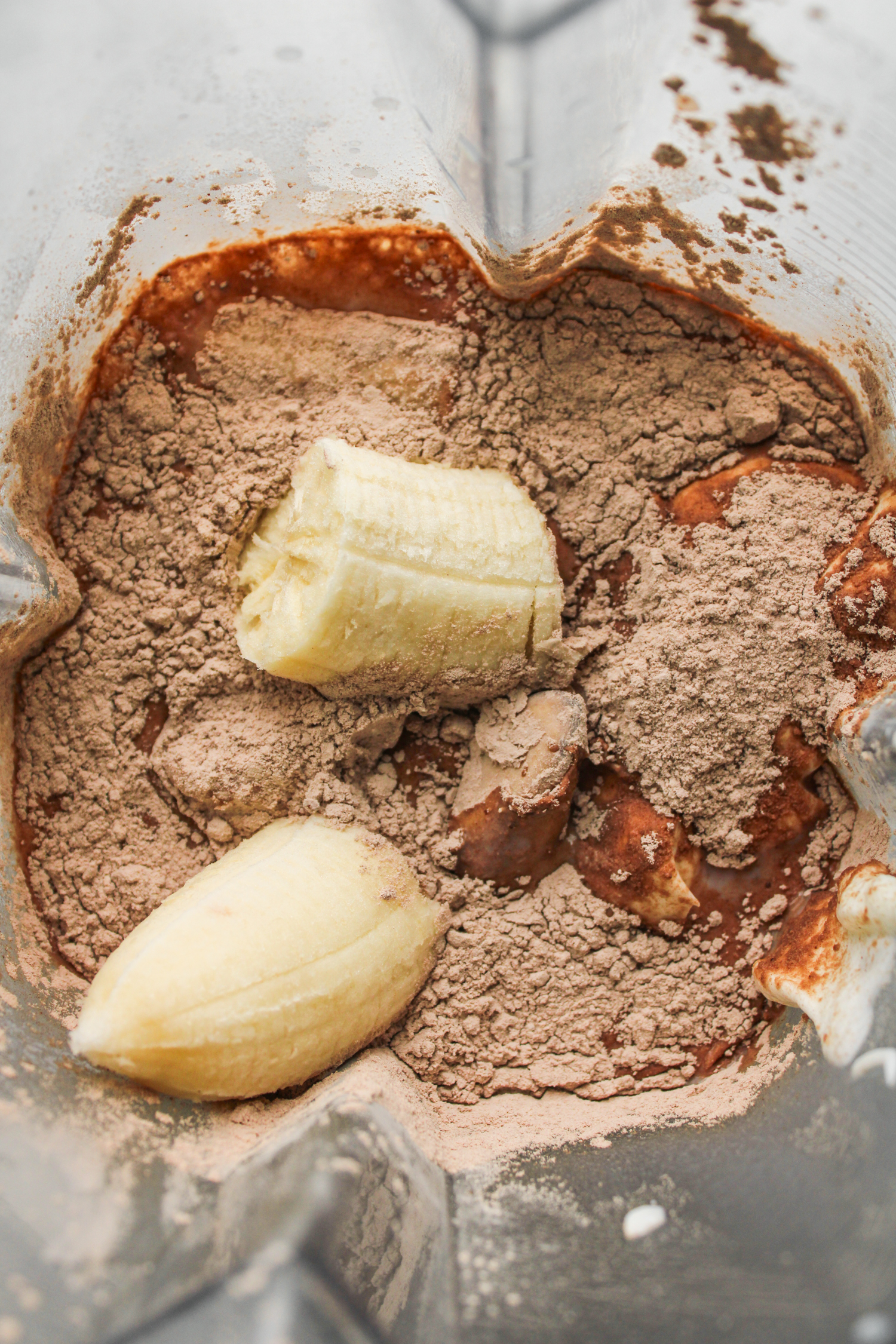 overhead shot of banana chocolate smoothie ingredients in the blender