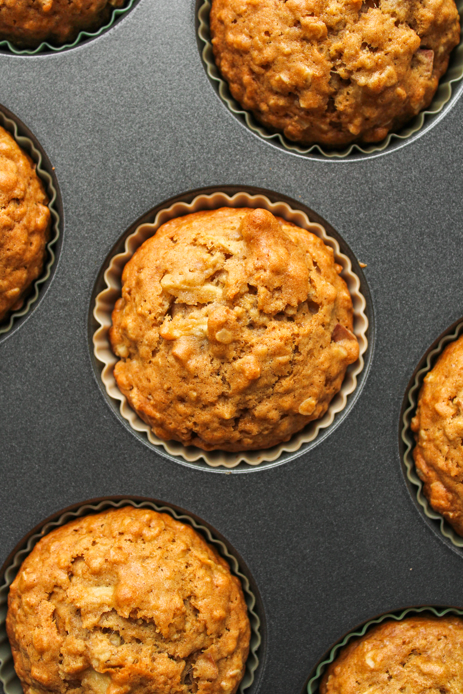 overhead shot of baked apple muffins still in the metal muffin tin