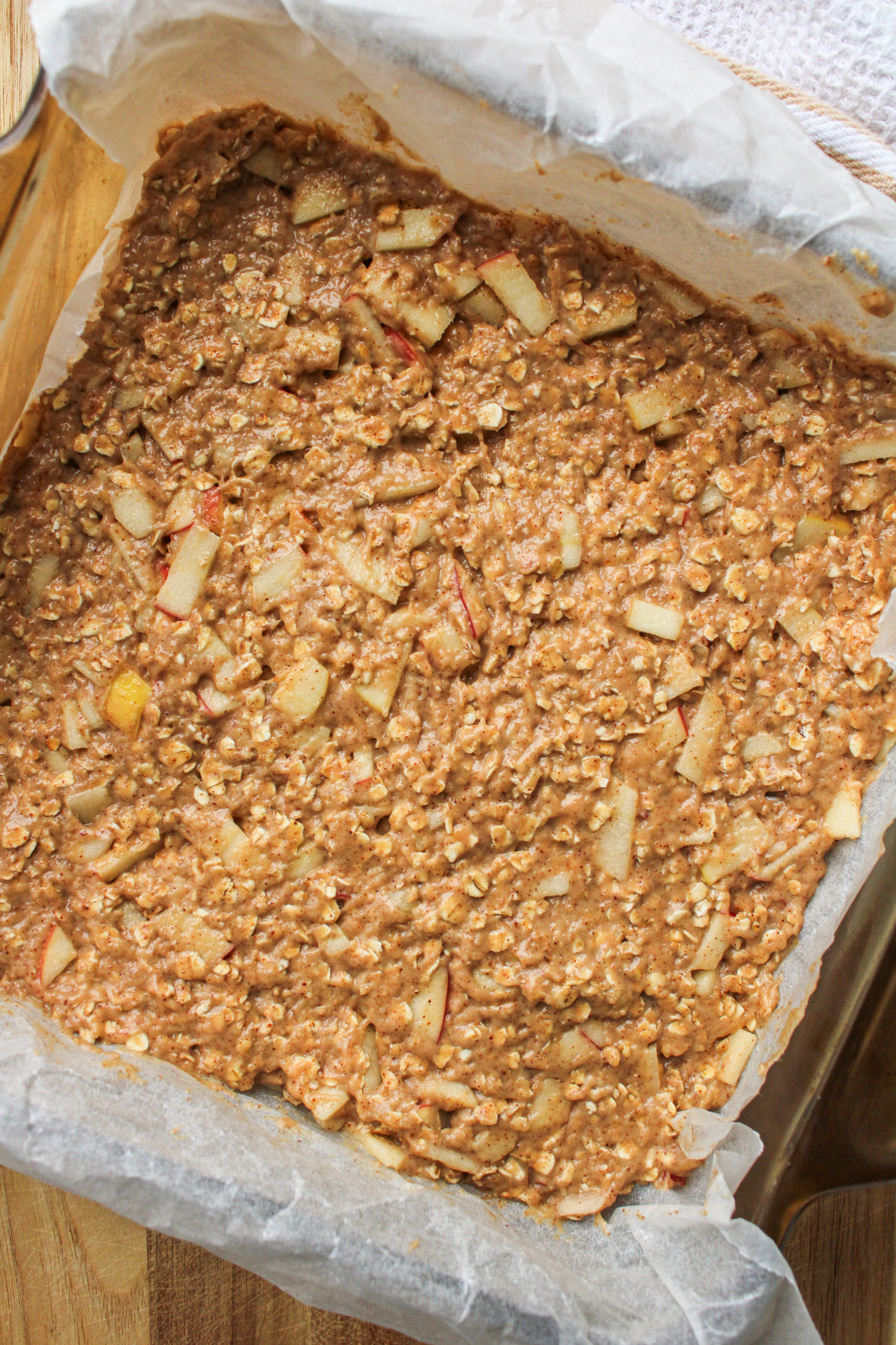 raw apple oatmeal bar batter in an 8x8" baking dish