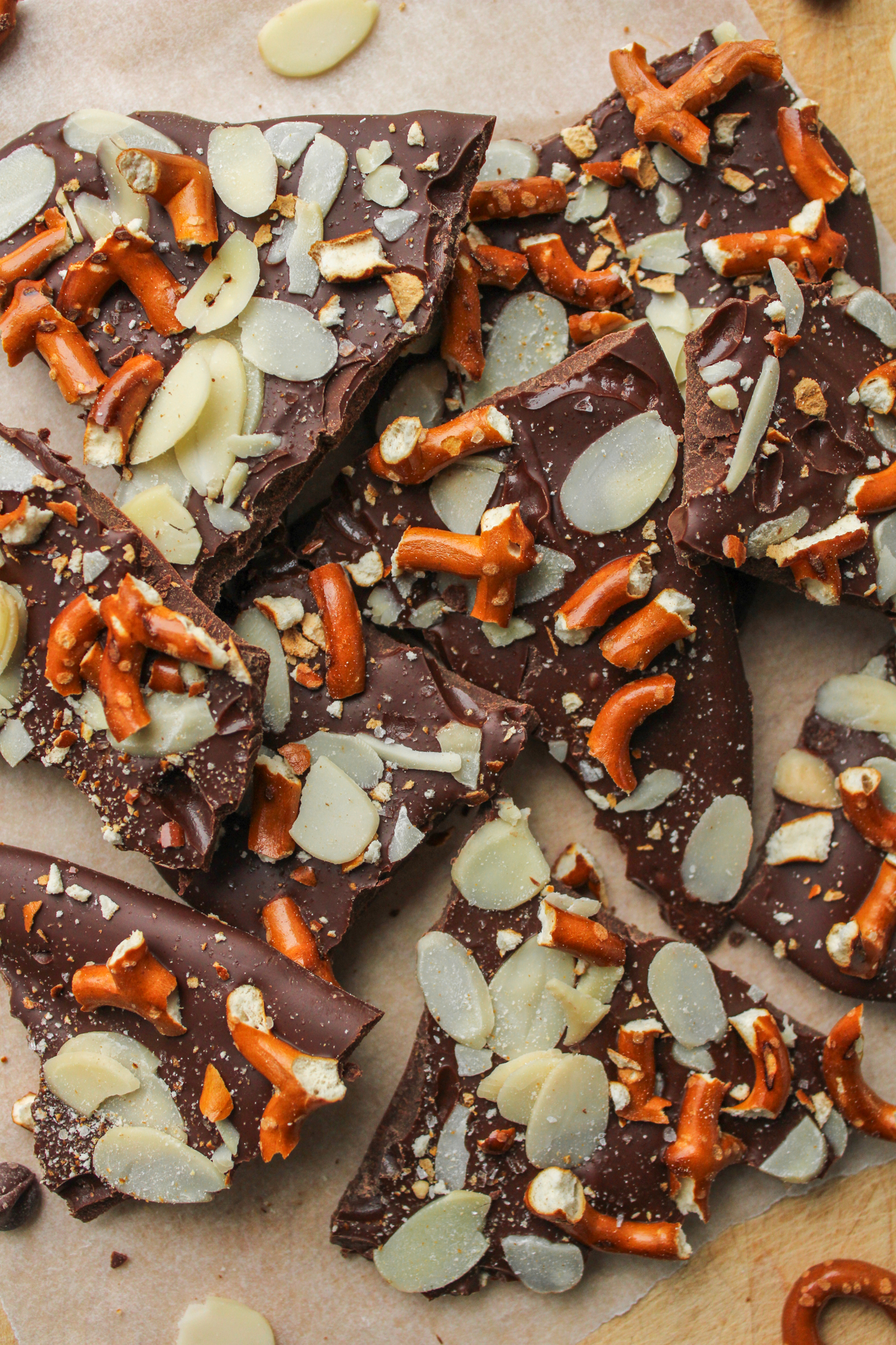 pretzel almond bark pieces on top of a wooden cutting board