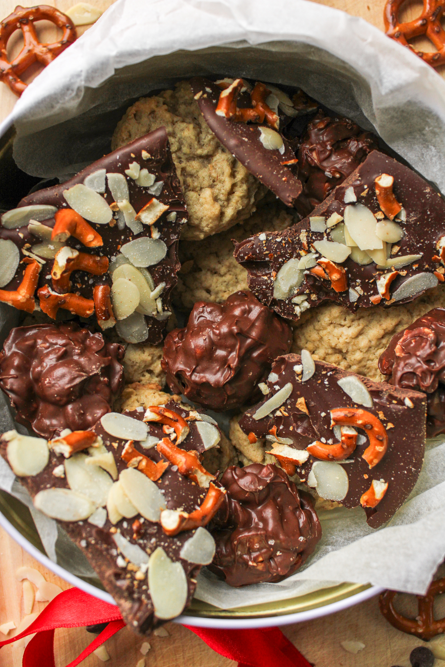 a holiday cookie box with pretzel almond bark, nut chocolate clusters and oatmeal cookies