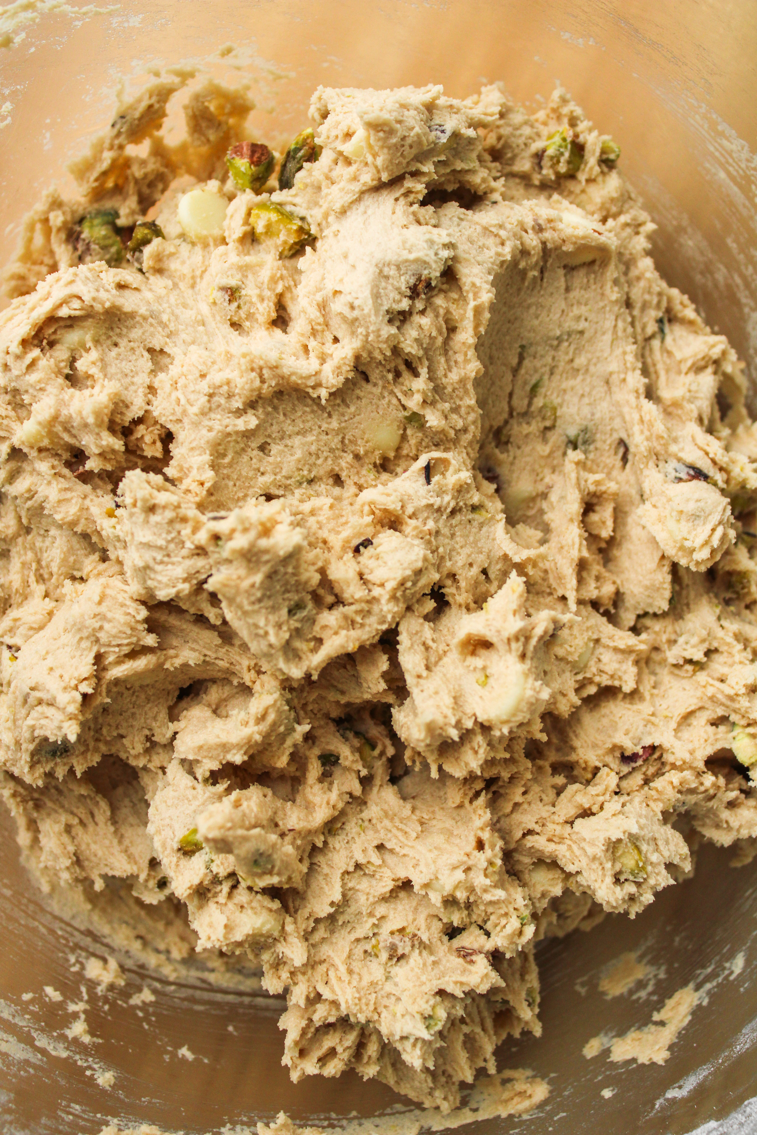 raw pistachio cookie dough in a large glass bowl