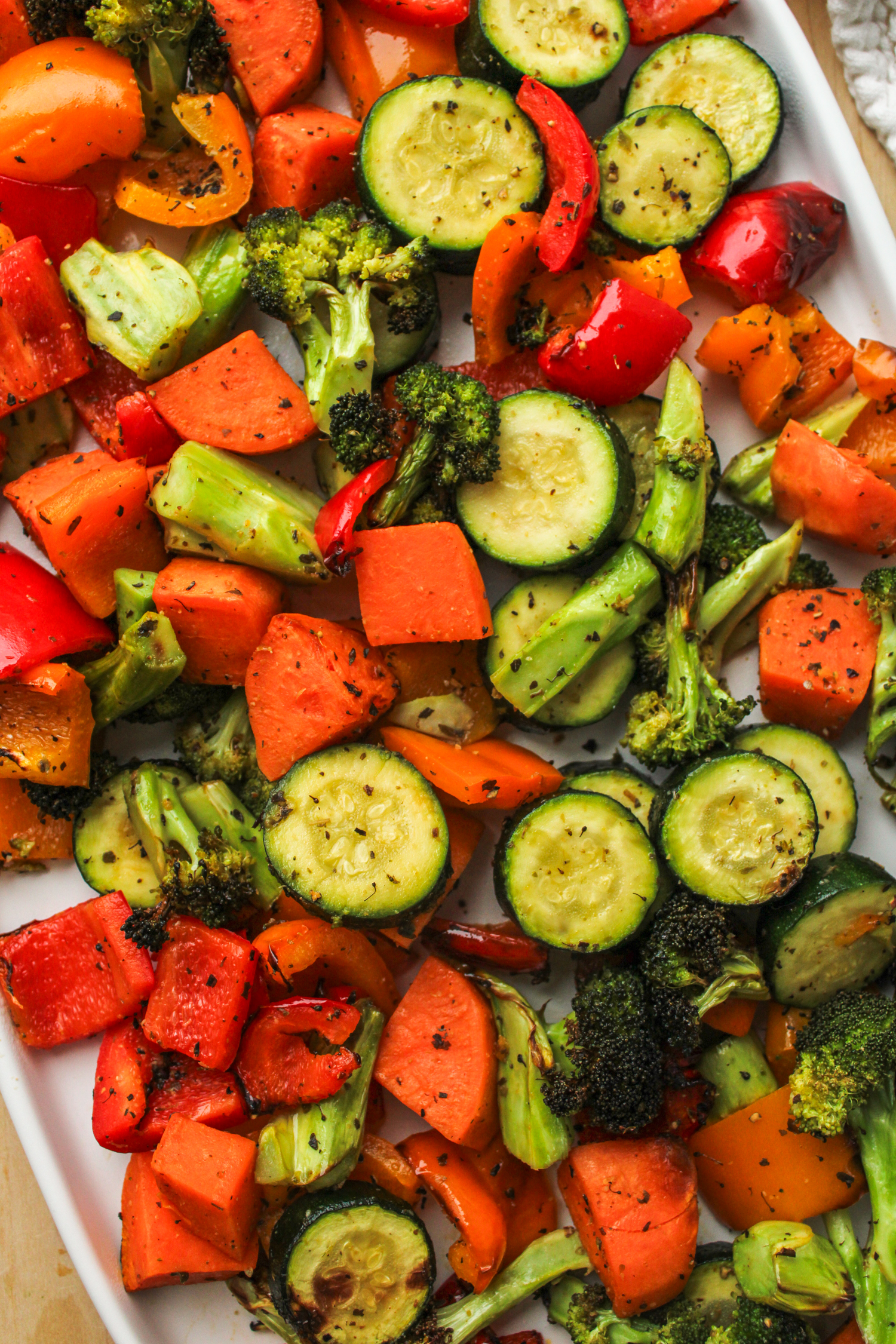 air fryer roasted vegetables on a large white ceramic serving plate