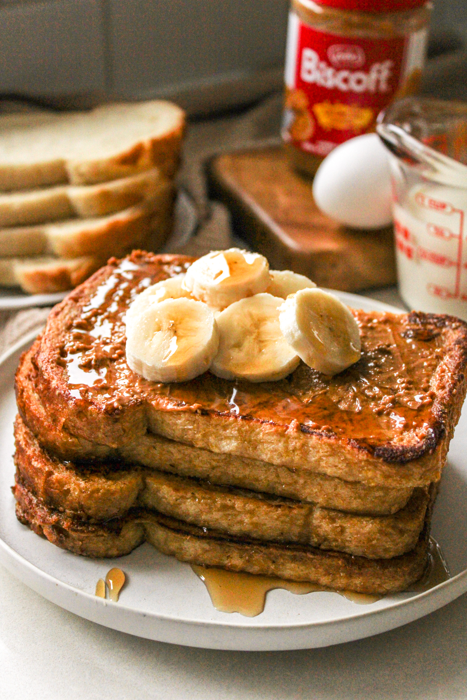 biscoff sourdough french toast topped with biscoff spread, sliced bananas and maple syrup