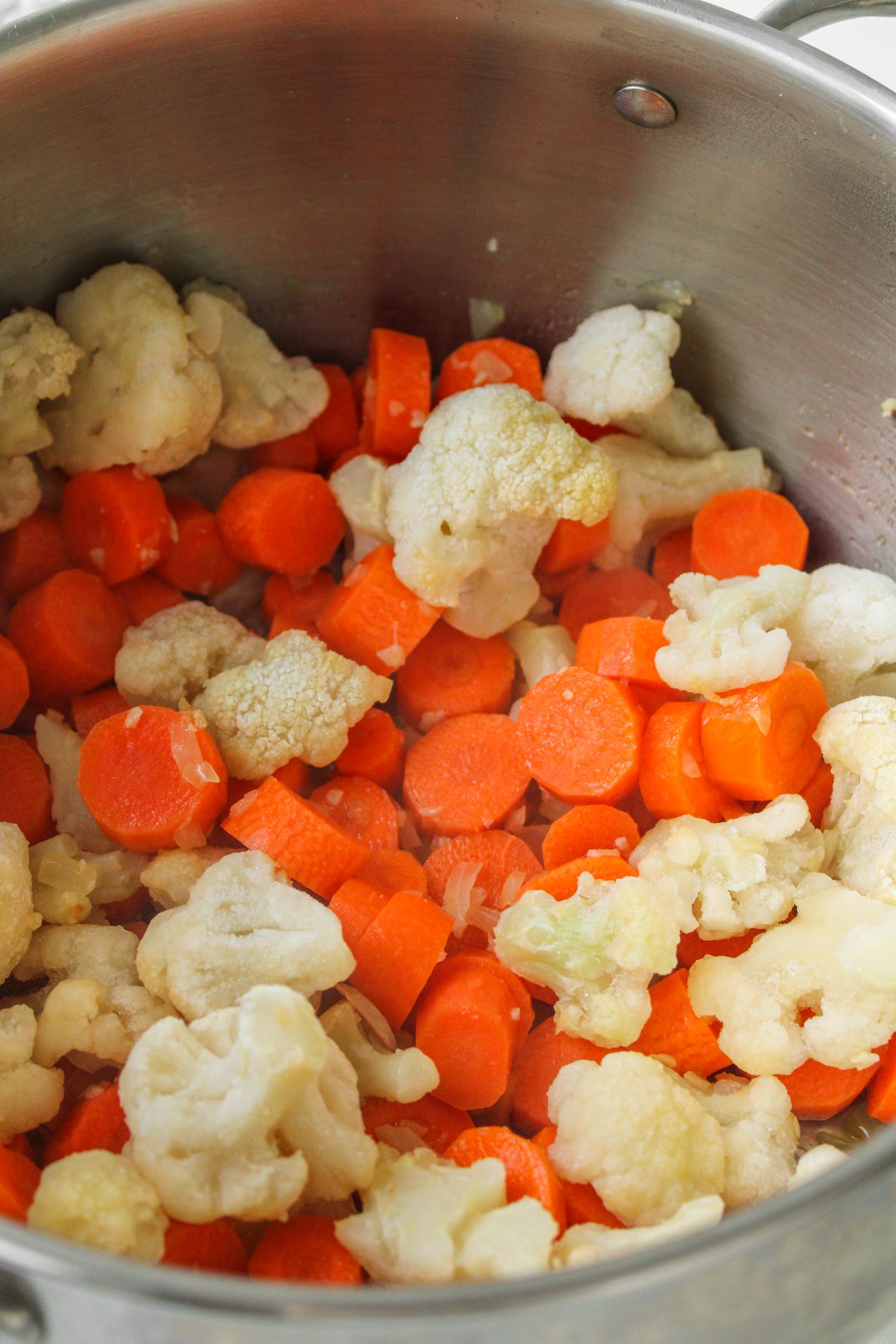 carrots and cauliflower cooking in a large pot