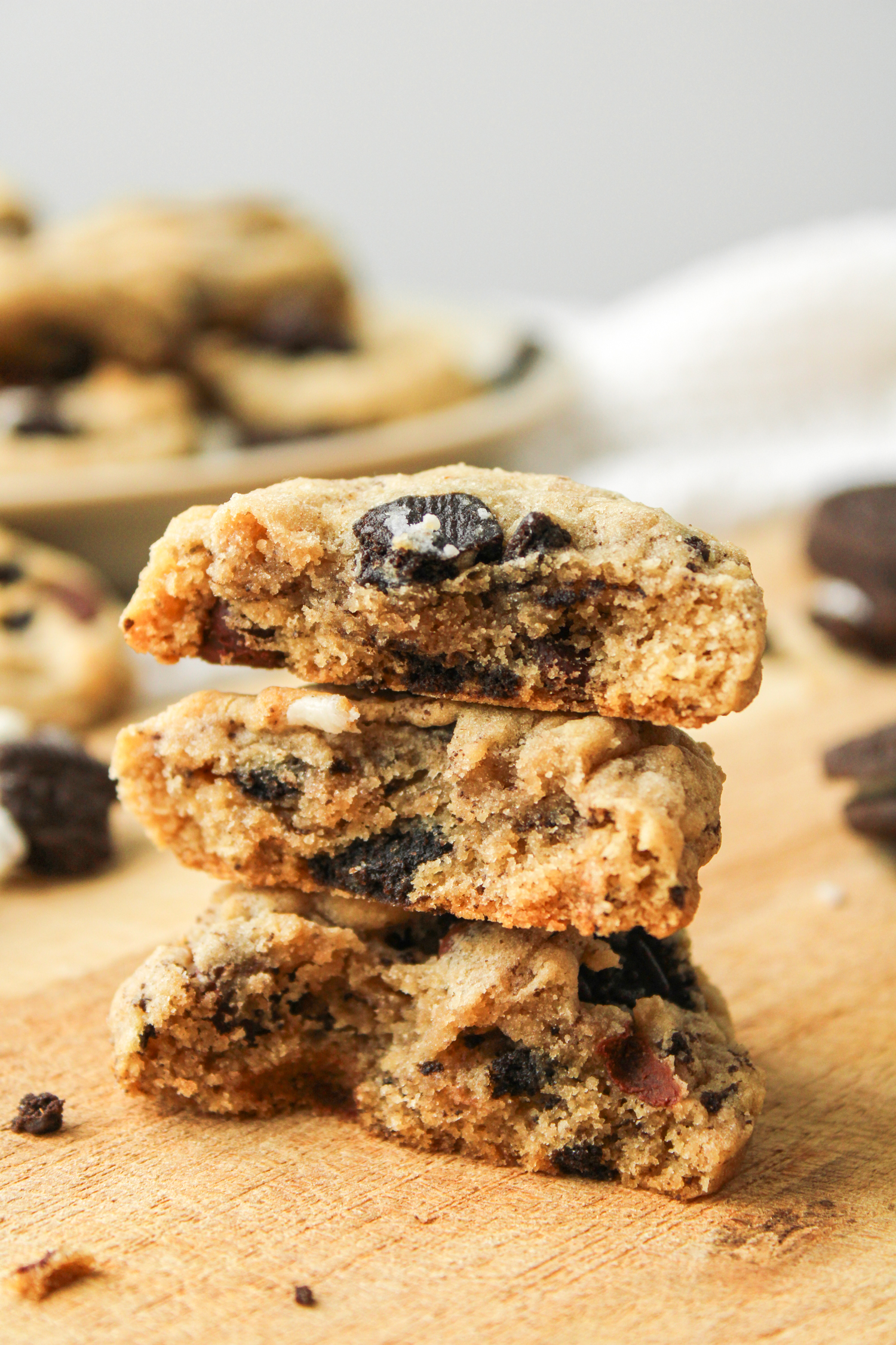 oreo chocolate chip cookie halves stacked on top of each other on a wooden board