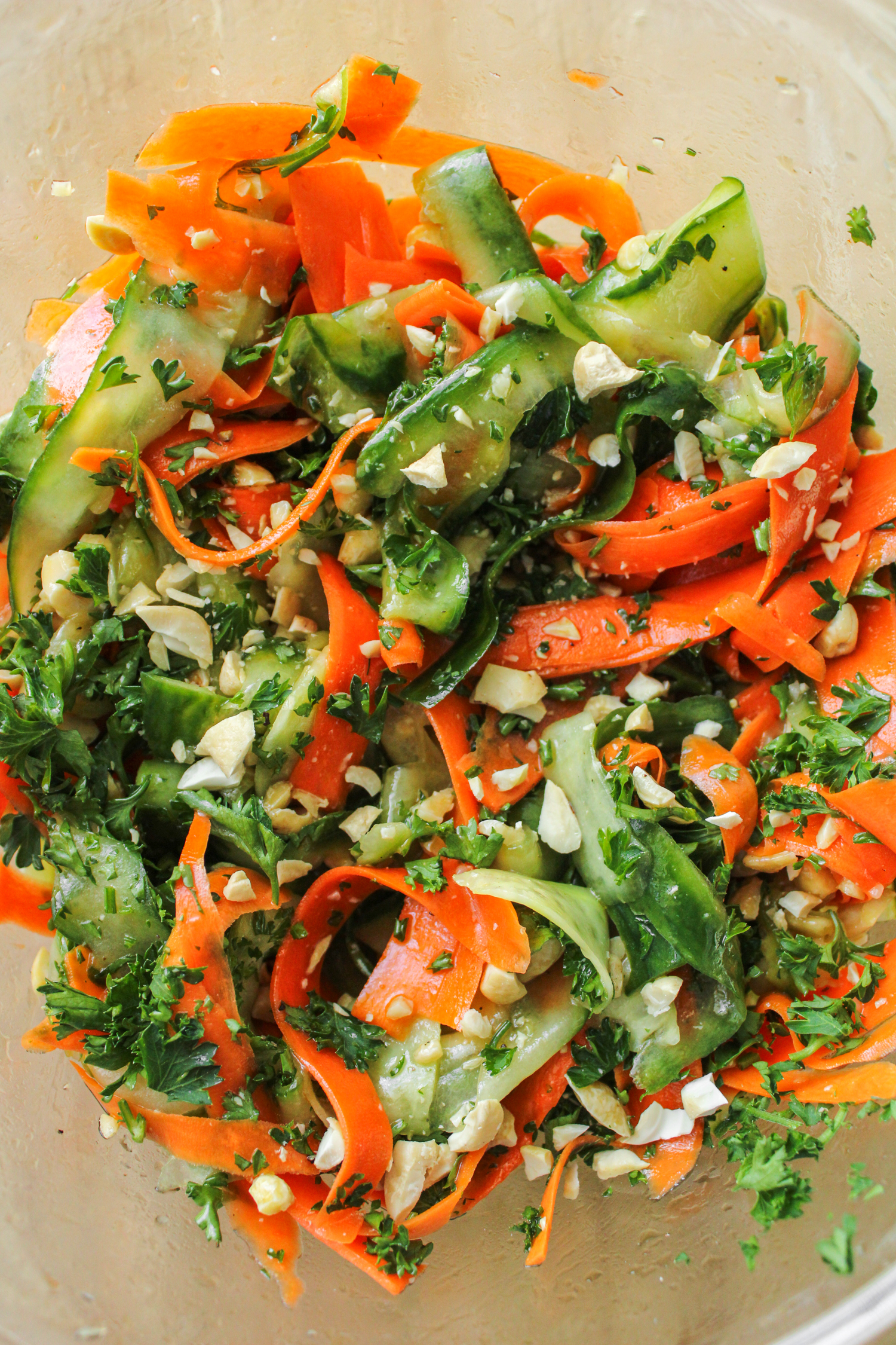 cucumber carrot salad in a large glass bowl
