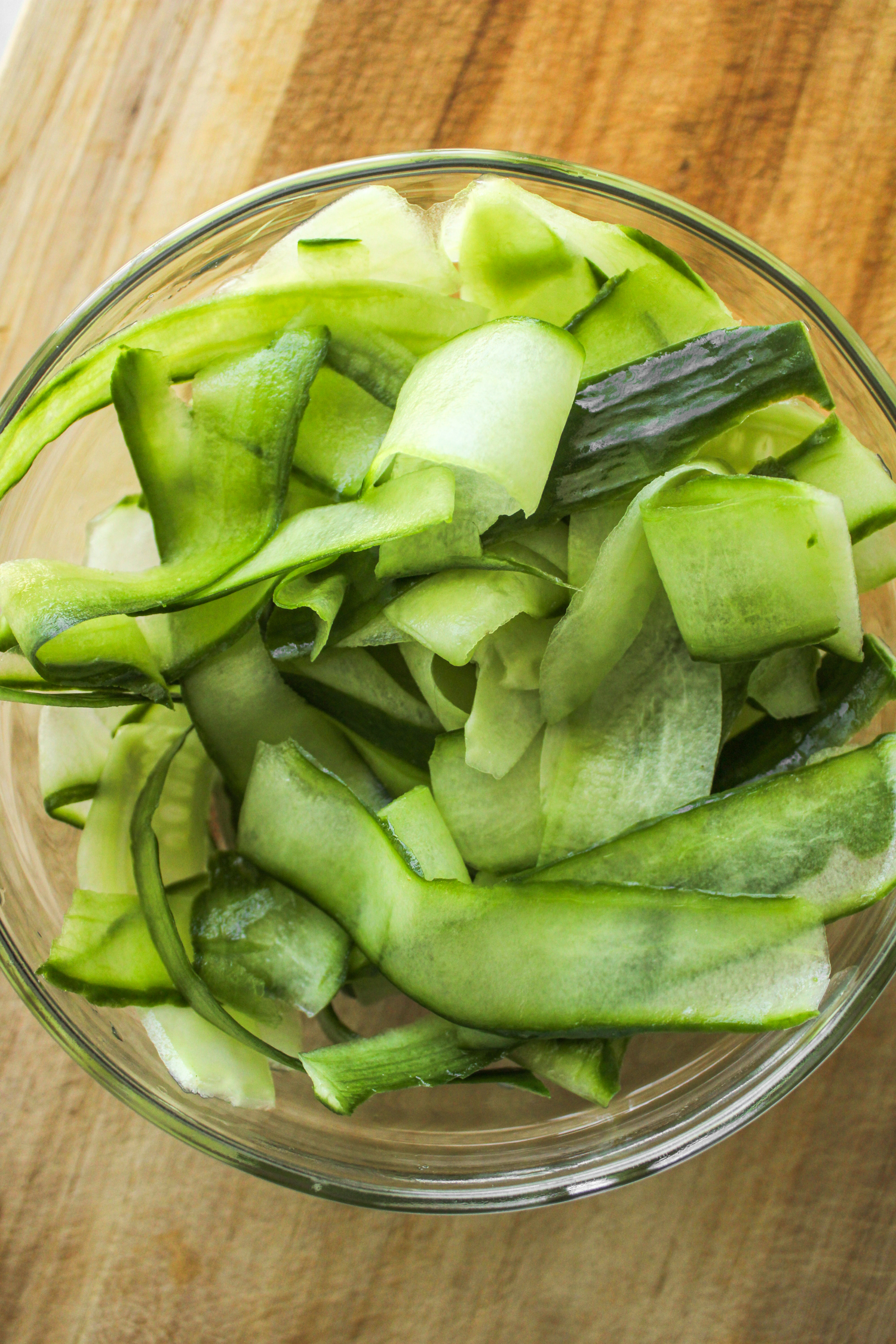 peeled cucumbers in a glass bowl